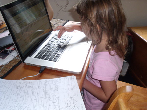 Charlotte typing her first blog post