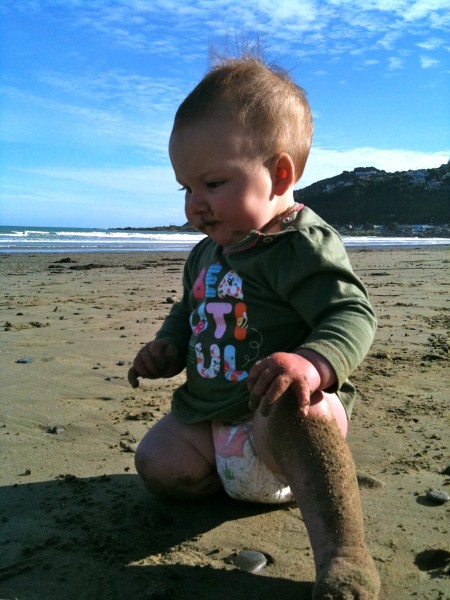 Alice, sand loving beach baby at 9 months