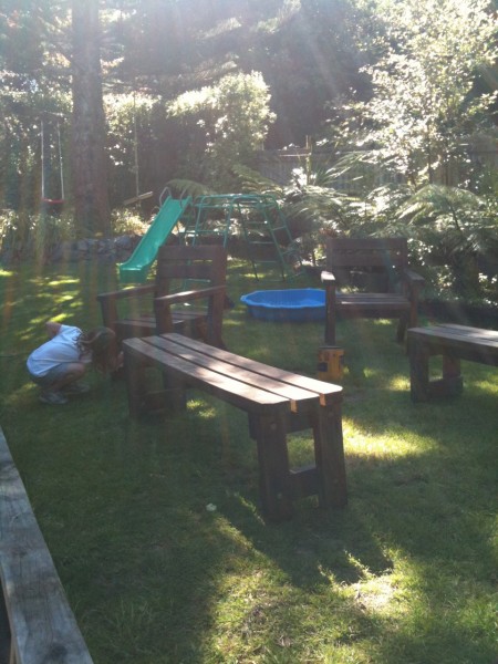 Charlotte varnishing the patio furniture