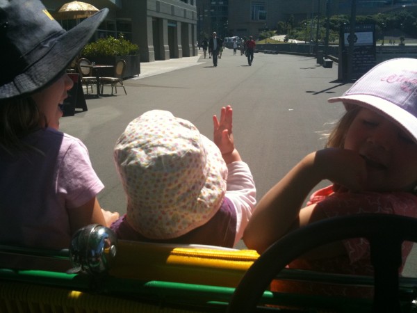 Alice giving the royal wave on her first croc bike ride