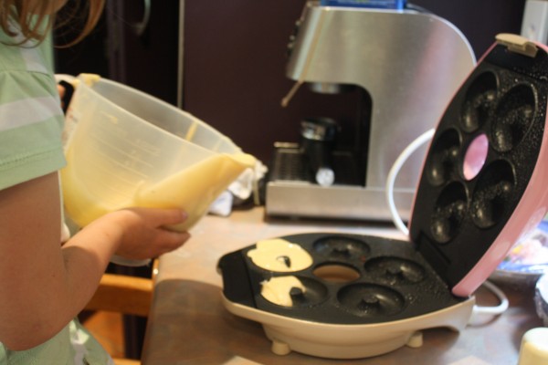 Sophie pouring in the doughnut batter