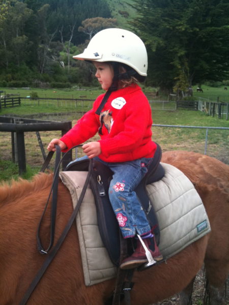 Sophie, age 3, riding in Nelson