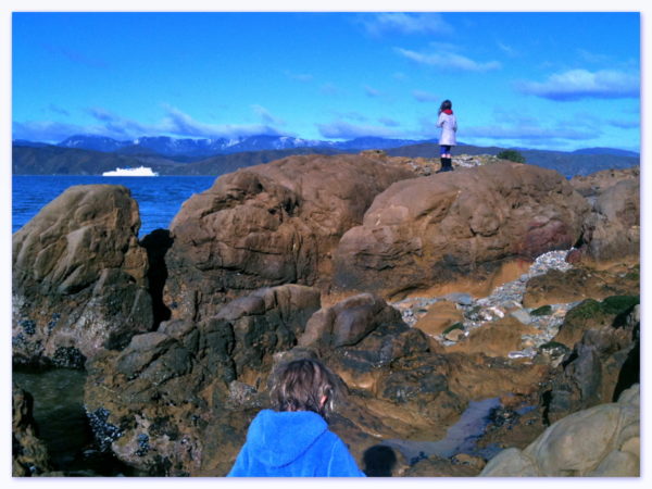 Snow on the distant Orongorongos, Charlotte watching a ferry leave Wellington harbour