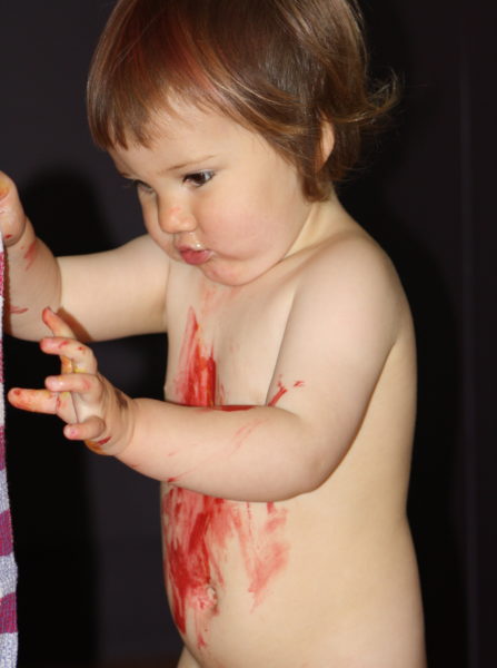 Alice trying to clean herself up after painting herself red!