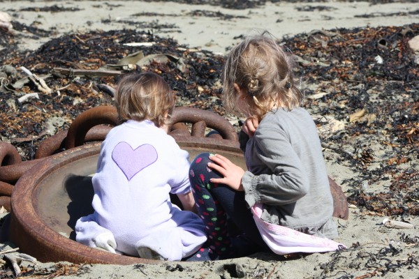 Alice & Sophie exploring an anchor chain on Island Bay beach