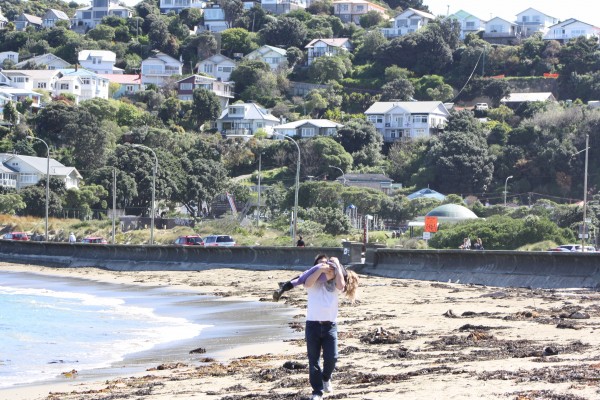 Dan carrying a giggling Charlotte along Island Bay beach