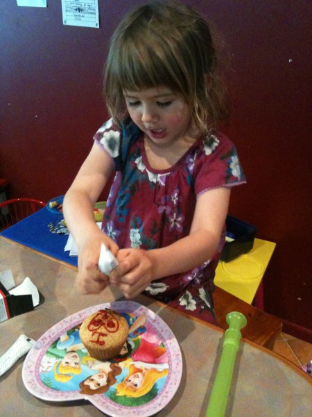 Decorating cupcakes with her friend