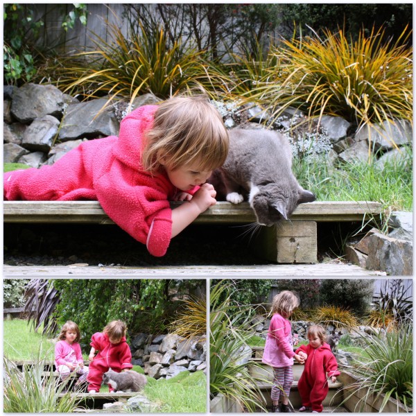 Sophie and Alice giving our cat some treats