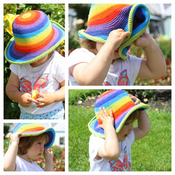 Alice at 22 months playing peek-a-boo with her sun hat in the rose gardens.