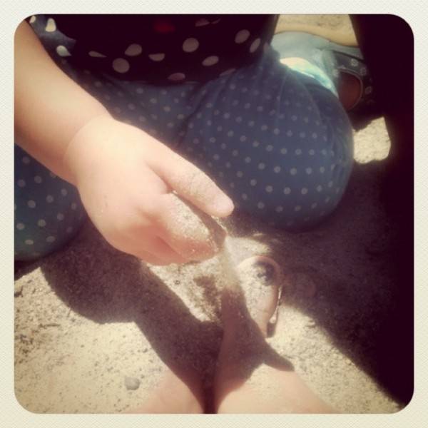 A sunshine day for Alice to bury Mummy's toes in sand