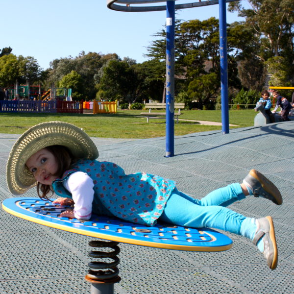 Alice pretending to ride a wave at Avalon Park, Lower Hutt