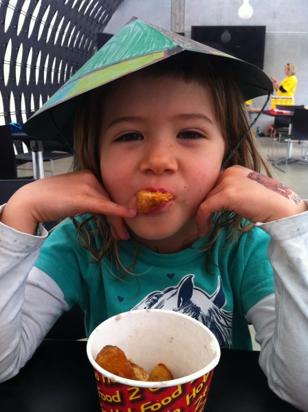 Sophie wearing the hat she made - and eating wedges!