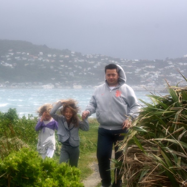 Dan, Charlotte & Sophie with on a very windy day near Lyall Bay, Wellington