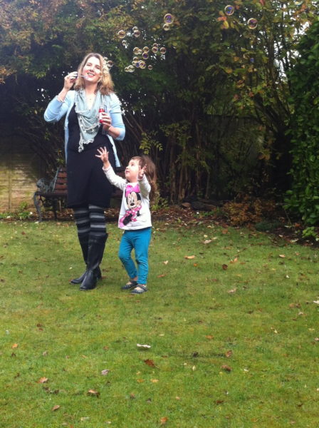 Bubble blowing with young Alice in Grandma & Granddad's garden