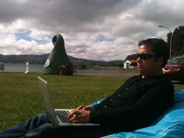 Dan trying to stay focused on work under a Middle of Middle Earth sky at Shelly Bay.