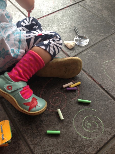 Alice drawing with chalk whilst waiting for dinner