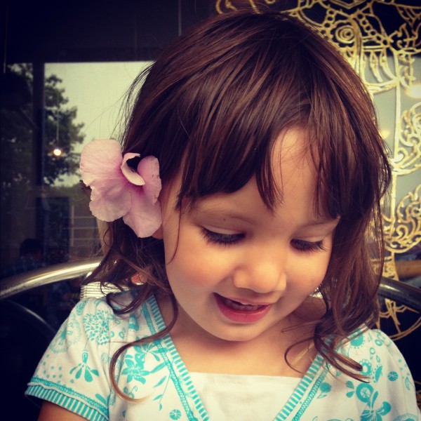 A flower in her hair and kiss curls Alice