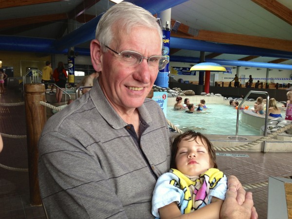 Alice in Granddad's arms after a swim in Nelson pool