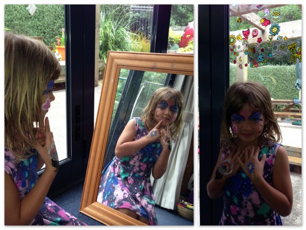 Sophie and her Geleez art on the window and Blingle art on the mirror