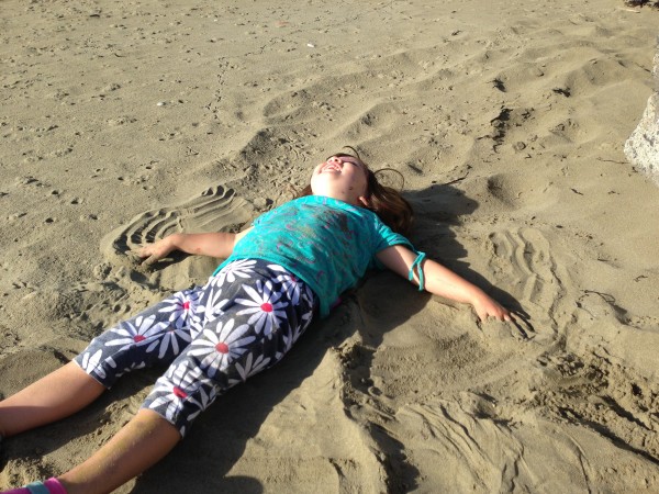 Making a sand angel with glee