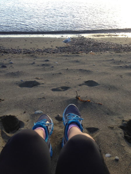 Finishing my run with a stretch on the beach at Princess Bay, Wellington