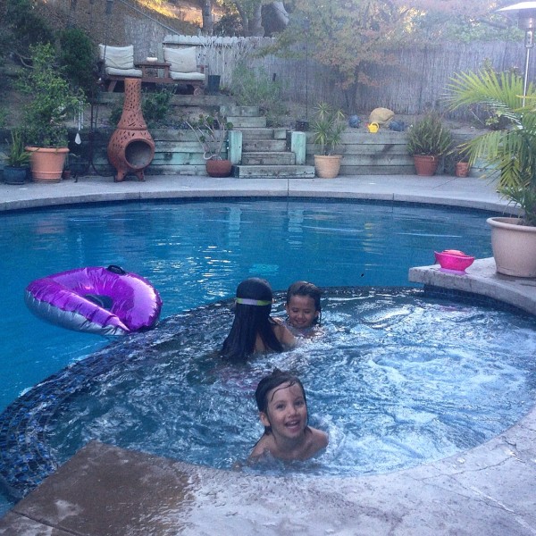 Sisters so happy playing in the pool together