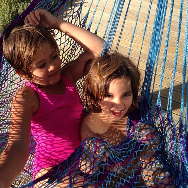 Sisters hanging out in a hammock in the Martinborough sun.