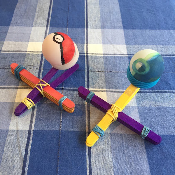 Pokemon balls from 'ping pong' balls and catapults from lolly pop sticks, elastic bands & bottle top lid.