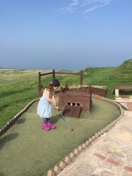 Alice showing us her mini-golf skills at Rocky Pines, summit of Great Orme