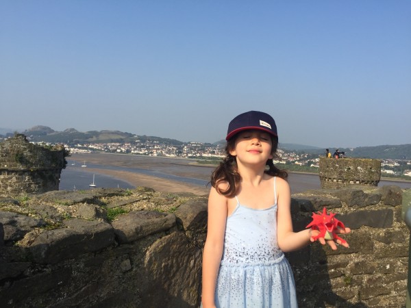 Alice on the walls of Conway Castle with her Welsh dragon