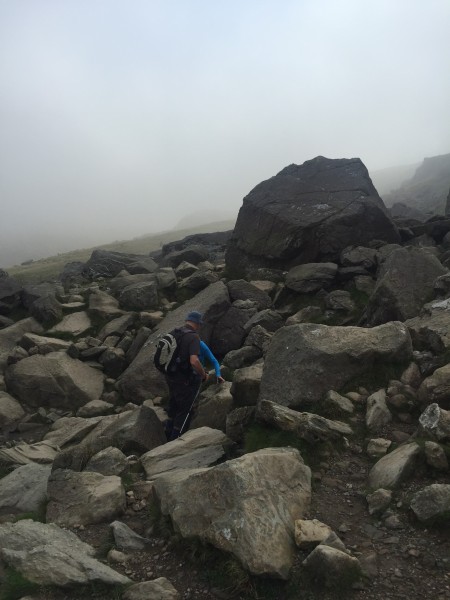 Grandad helping Grandma to navigate some tricky rocks on the first part of the climb up the Pgy Track.