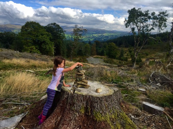 Alice placing a lucky stone on top of the cairn.