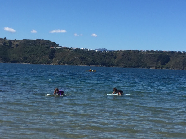 Sophie and Alice having a 'paddle off' on their boards!