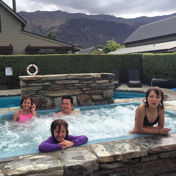 Hubby and our three daughters enjoying the spa pool at the Wanaka Luxury Apartments