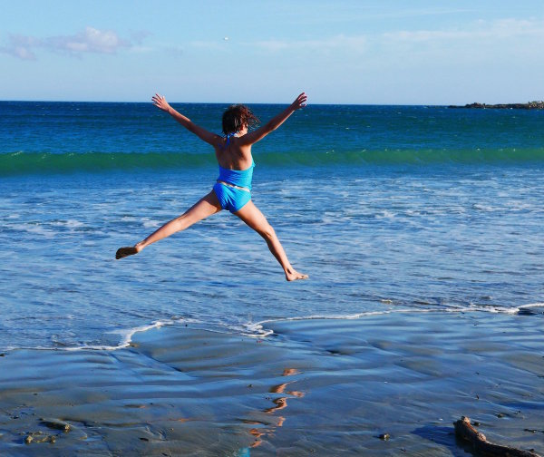 Sophie jumping into the sea at Lyall Bay
