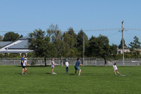 Tennis cricket with the children on the school field in Martinborough.